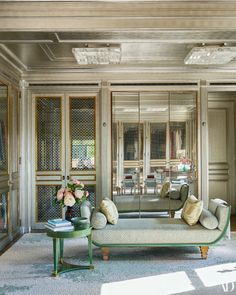 a living room filled with furniture and mirrors