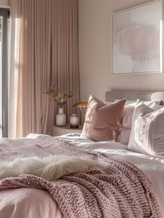 a bedroom with pink bedding and pillows