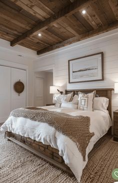 a large bed sitting under a wooden ceiling