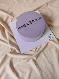 a cake with the word minetten on it sitting on top of a sheet