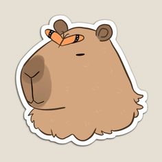 a brown bear sticker with an orange nose on it's head and eyes