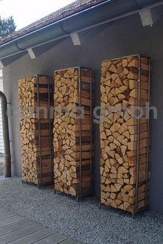 three stacks of wood sitting next to each other in front of a building