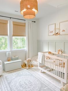 a baby's room with white furniture and decor