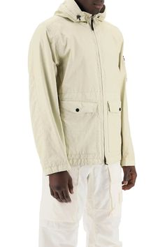 Stone Island Beige Jacket with Hood Designer's ID: 801541123V0091 Constructed from crinkle-finish garment-dyed nylon, this jacket is equipped with an internal wind and water-resistant breathable membrane to keep you protected in any weather condition. The adjustable hood, featuring an elastic drawstring, adds versatility, while the two-way zipper closure ensures ease of wear. With patch pockets featuring flaps and hidden zippers, as well as adjustable cuffs and hem with inner drawstrings, this jacket offers customizable comfort. Branded with the iconic removable Stone Island badge on the sleeve. This jacket is crafted with ECONYL® regenerated yarns and cutting-edge coating technology, providing a metallic sheen and iridescent finish without compromising on durability and adaptability. Comp Beige Jacket, Jacket With Hood, Stone Island, Compass, Stone, Color, Design