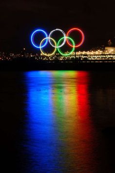 the olympic rings are lit up at night