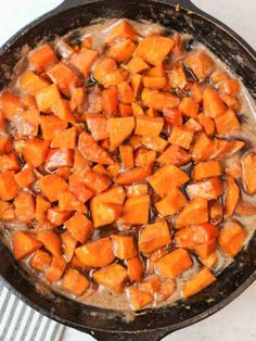 a pan filled with cooked sweet potatoes on top of a stove