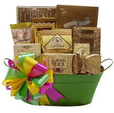 a green bucket filled with lots of different types of food and candy bars on top of it