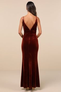 the back of a woman wearing a red velvet dress