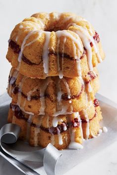 a stack of bundt cakes sitting on top of a white plate covered in icing