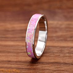 Solid 925 Sterling Silver 4mm Width Pink Opal Inlay Wedding Ring Band ▷Gift Box Included ▷Size 5- 10 Available ▷4mm Height ▷High-Quality Lab Created Pink Opal ▷925 Sterling Silver (not plated or filled) ▷925 Stamp Authenticity Pink Sterling Silver Opal Ring For Anniversary, Pink Opal Ring In Sterling Silver For Anniversary, Pink Sterling Silver Stackable Rings For Wedding, Pink Wedding Rings With Polished Finish, Pink Band Jewelry For Gifts, Pink Band Jewelry Gift, Silver Opal Ring With Polished Finish For Wedding, White Band Jewelry Gift, Silver Opal Toe Ring For Wedding