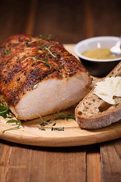 a wooden plate topped with meat and bread