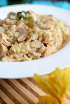 a white plate topped with pasta and mushrooms