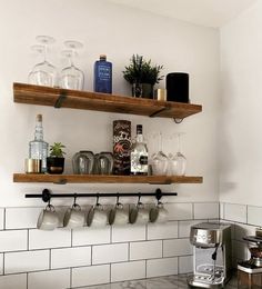 the shelves above the stove are filled with wine glasses and cups, along with other kitchen utensils