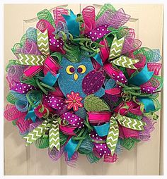 a colorful wreath with an owl on it