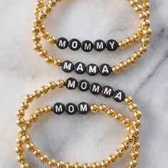 This custom Mom bracelet is the little hint of shine to add to your bracelet stack — and with your own choice of word, it's the perfect gift! Choose any initial, name, word or short phrase (up to 15 letters)! Request your custom word or phrase by adding it in the "Special Instructions for Seller" box in your cart 5mm round gold-plated beads letter beads available in black or white stretch cords for easy on and off four sizes: Extra-Small (6"), Small (6.5"), Medium (7"), Large (7.5") packaged in Mom Bracelet Personalized, Mama Bracelet, Mom Bracelet, Word Bracelet, Moms Bracelet, Dangle Hoop Earrings, Bead Bangles, Letter Beads, Name Bracelet