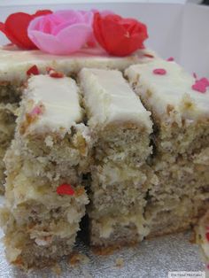 a piece of cake with white frosting and pink flowers on top