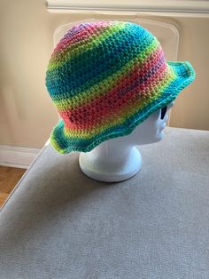 "hand crocheted bucket hat Size: S-M Crown: 7\" Height: 8.5\" Width: 11\" Head circumference: 22-24\" Trendy fashionable hat to wear anywhere and anytime." Casual Knitted Bucket Hat, Multicolor Curved Brim Crochet Hat, Knitted Yarn Cloche Hat For The Beach, One Size Yarn Bucket Hat For Spring, Handmade Yarn Bucket Hat For Spring, Multicolor Crochet Bucket Hat With Short Brim, Spring Bucket Hat In Yarn, One Size, Multicolor Brimmed Crochet Hat In Cotton Yarn, Casual Knitted Cotton Yarn Hat