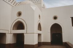 a white building with arches and doorways