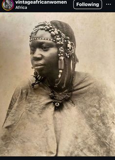 an old black and white photo of a woman with braids on her head, looking at the camera