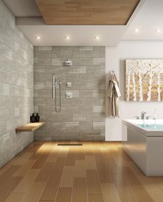 a modern bathroom with wood floors and tile walls