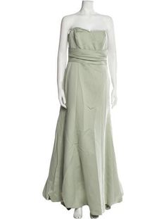 a mannequin wearing a green dress on a white background