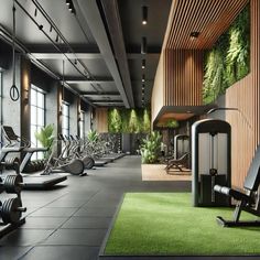 an indoor gym with treadmills, exercise machines and green plants on the wall