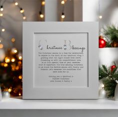 a white frame with the words christmas blessing on it next to some christmas decorations and lights