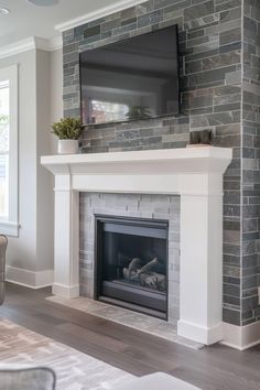 a fireplace with a flat screen tv mounted above it's mantel in a living room