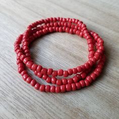 These bracelets are made up of glass seed beads in an opaque red color. Perfect for stacking together, wearing alone, or pairing with a chunky bracelet. The options are endless! (Bracelets sold individually) Great as gifts! Size shown: 7 inches Strung on pre-stretched bracelet material. CUSTOMIZATION If you are interested in seeing this bracelet in another color not represented in the shop, please message me via conversations. I would love to help! SIZING The sizing chart is the standard for str Red Bohemian Beaded Bracelet, Red Oval Beaded Bracelets For Gift, Red Beaded Stretch Bracelet, Red Beaded Bracelets For Beach, Red Hand-strung Friendship Bracelets With Round Beads, Red Beaded Bracelets With Spacer Beads For Beach, Red Hand-strung Beaded Bracelets For Beach, Red Stretch Bracelet With Large Beads, Hand-strung Red Friendship Bracelets With Round Beads