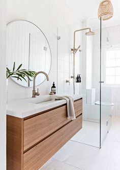 a bathroom with a sink, mirror and shower stall in it's center area