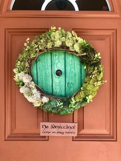 a green door with a wreath on it