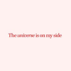 the phrase is written in red on a light pink background that says, the universe is on my side