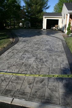 a driveway is taped off with yellow tape