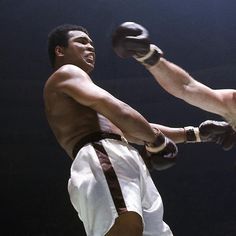 two men in white shorts and black boxing gloves