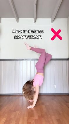 a woman doing a handstand on the floor in front of a sign that says, how to balance handstand