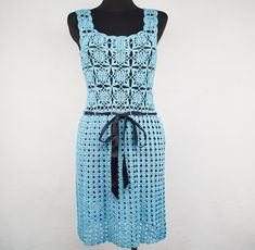 Embrace boho chic style with this Handmade Crochet Midi Dress in Light Blue. This sleeveless summer outfit features a U-neck and an intricate floral crochet pattern that offers a see-through design, perfect for warm weather. The dress is accented with a black ribbon belt, adding a touch of elegance while enhancing its flattering fit. Ideal for beach outings, casual gatherings, or special occasions, this dress is a versatile and stylish addition to any wardrobe. Condition: used, great vintage, no Light Blue Sleeveless Beach Dress For Summer, Light Blue Sleeveless Dress For Summer Beach, Fitted Blue Bohemian Sleeveless Dress, Light Blue Sleeveless Summer Beach Dress, Blue Fitted Sleeveless Bohemian Dress, Blue Sleeveless Bohemian Crochet Dress, Sleeveless Multicolor Crochet Lace Dress, Bohemian Spring Knee-length Crochet Dress, Blue Crochet Sleeveless Dress