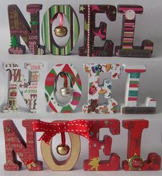 the word noel spelled with christmas decorations and bells on top of each letter is decorated in red, green, white and gold