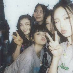 a group of young women posing for a photo together with one woman making the peace sign