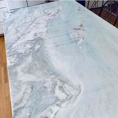 a kitchen counter top with white marble on it