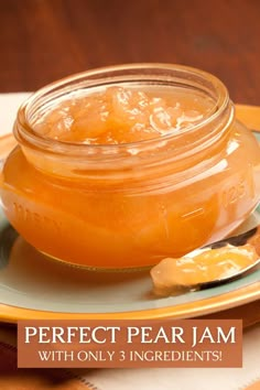 a glass jar filled with honey sitting on top of a plate next to a spoon