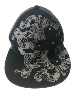 a black and white hat with an ornate design