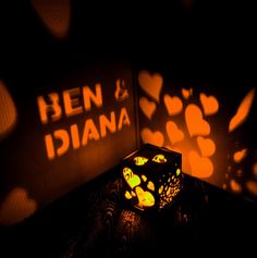 a lit up box sitting on top of a table next to a sign that says ben and idiana