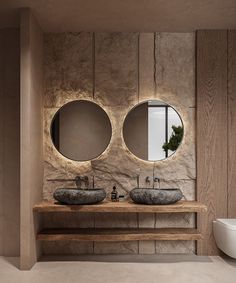 a bathroom with two sinks and mirrors on the wall