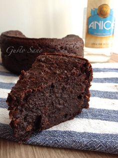 two pieces of chocolate cake sitting on top of a blue and white towel