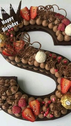 the letter s is decorated with chocolate and strawberries