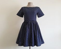 Navy Blue Polka Dot Dress - Fabric : cotton canvas - Invisible nylon zipper on the back - Boat neckline - Short sleeve - Lined - Ready to ship in 1-3 business days Measurements : Shoulders : 14.5" Bust : 34" Waist : 28" Hips : free Sleeves : 8" Total length : 32" Shoulder to waist : 13" Please read the product description carefully before purchasing to ensure it meets your needs. If you have any questions, please feel free to contact us. Thank you very much for visiting our shop. Navy Cotton Mini Length Dresses, Navy A-line Cotton Dress, Navy Cotton A-line Dress, Fitted Navy Cotton Dresses, Navy Fitted Cotton Dress, Knee-length Cotton Polka Dot Dress, Knee-length Polka Dot Cotton Dress, Cotton Knee-length Polka Dot Dress, Polka Dot Cotton Knee-length Dress