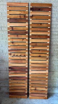 two wooden slatted doors sitting next to each other