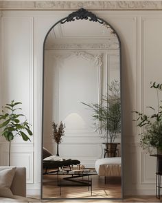 a large mirror in the middle of a living room with plants and couches around it