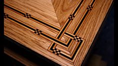 a close up of a wooden box with black lines on the top and bottom part