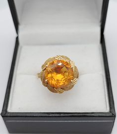 Large round cut orange sapphire set on a 18K gold ring The sapphire, possibly synthetic, measures 11 x 6.3 mm and weighs approx 6 Ct. It is loupe clean of any inclusion, giving a very nice flamboyant and warm effect. The flower design is typical of the 1950s era Weight of the ring : 5 Gr Size : US 6 3/4 - UK N 1/2 - FR 54 Possibility to resize for a flat fee of 40 euros equivalent. Please allow 6-9 working days for the modification to be done as we do not perform the alteration ourselves but use Orange Topaz Round Ring, Formal Yellow Gold Round Sapphire Ring, Vintage Gold Sapphire Ring With Round Cut, Formal Gold Sapphire Ring With Diamond Cut, Gold Sapphire Ring With Diamond Cut For Formal Occasions, Formal Orange Round Jewelry, Formal Orange Jewelry, Vintage Gold Sapphire Round Ring, Formal Citrine Orange Rings